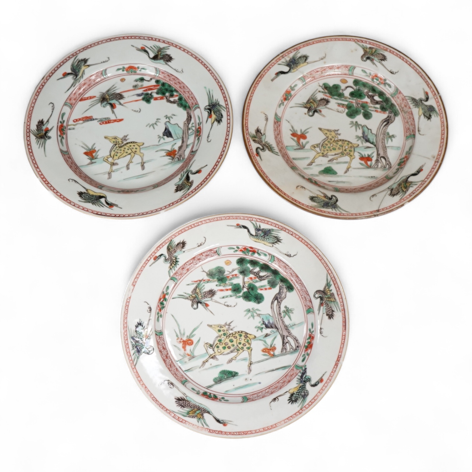 Three Chinese famille verte deer and crane plates, Kangxi period, 22cm in diameter
